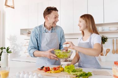 Gülümseyen baba ve kız birlikte yemek salata çok memnun