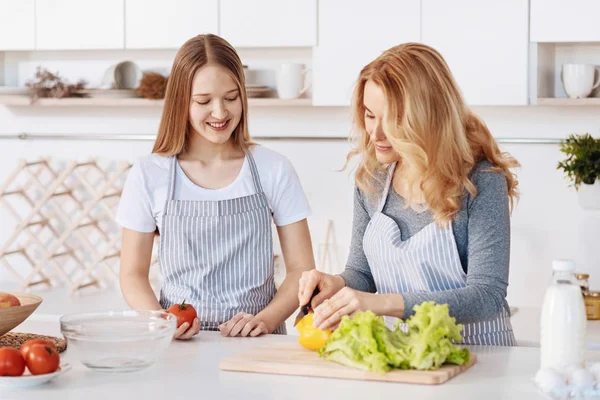 Positive mother cooking with her daughter — Stock Photo, Image