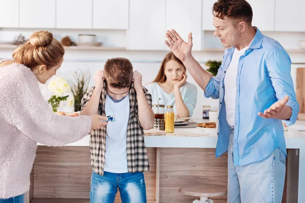 Furious family couple punishing their little son — Stock Photo, Image