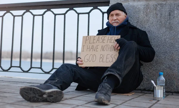 Nezaměstnaní starší muž sedí na lepenkové krabice — Stock fotografie