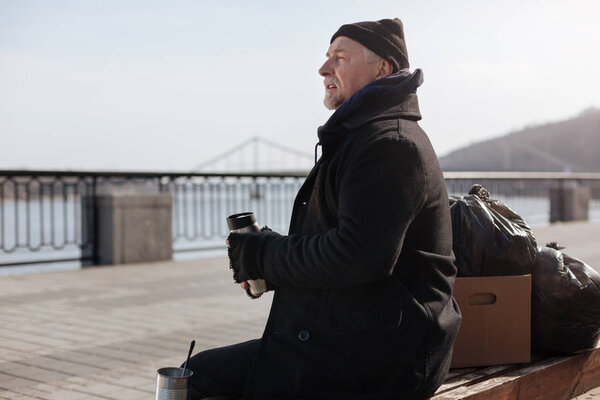 Homeless man having rest on the bench