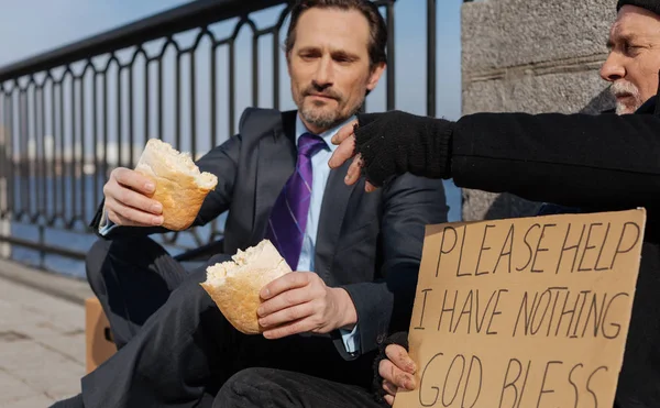 Photo of hungry men looking at small loaf — Stock Photo, Image