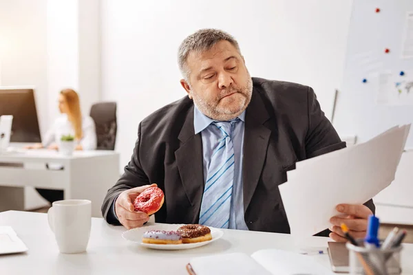 Busy engaged employee eating at his workplace — Stock Photo, Image