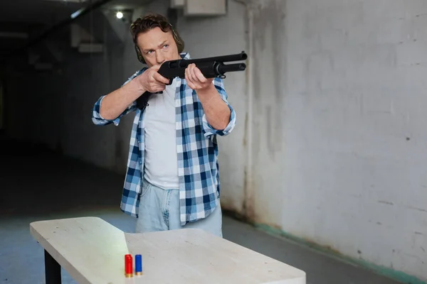 Nice handsome man holding a gun — Stock Photo, Image