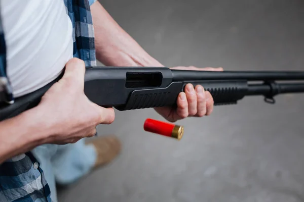 Red riffle bullet dropping out of the gun — Stock Photo, Image