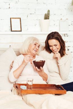 Büyüleyici torunu ile sevimli büyükanne evde kahvaltı keyfi