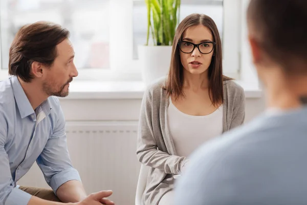 Serious brunette looking at her colleague — Stock Photo, Image