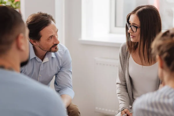 Positive delighted female sitting in semi position — Stock Photo, Image