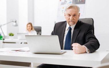 Impatient aged employer expressing fury in the office clipart