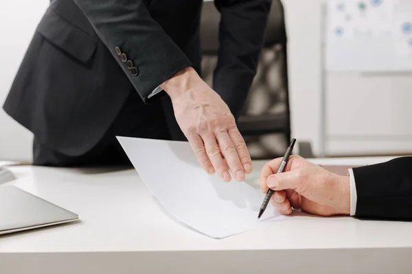 Confident businessman signing the important document in the office — Stock Photo, Image