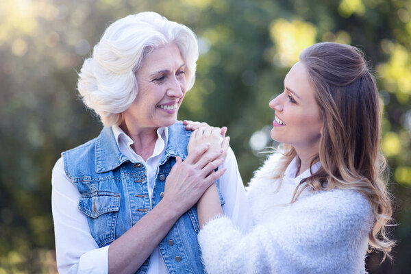 woman enjoying with retired mother in park