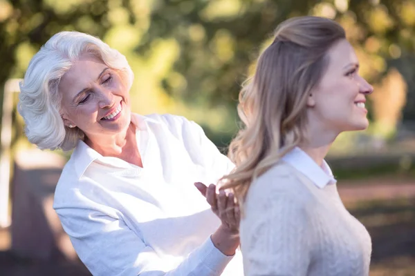 woman expressing care of mature daughter