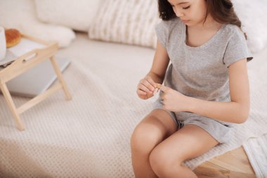 Kendine güvenen çocuk tıbbi yama parmağında evde koyarak