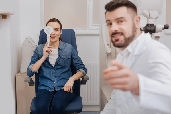 Cheerful joyful woman looking at the eye chart — Stock Photo, Image