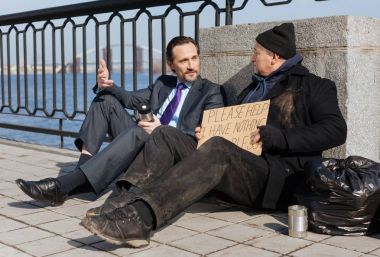 Attractive businessman telling his story to homeless clipart