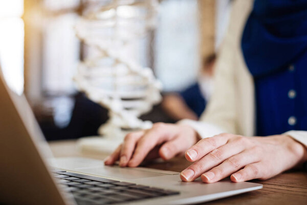 Close up of laptop used by young female scientist