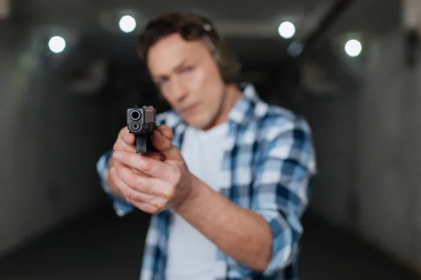 Nice brutal marksman aiming with a handgun — Stock Photo, Image