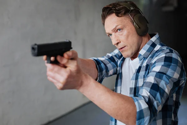 Nice serious man visiting the shooting range — Stock Photo, Image