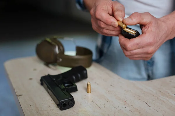 Close up of a bullet being put into the cartridge clip — Stock Photo, Image