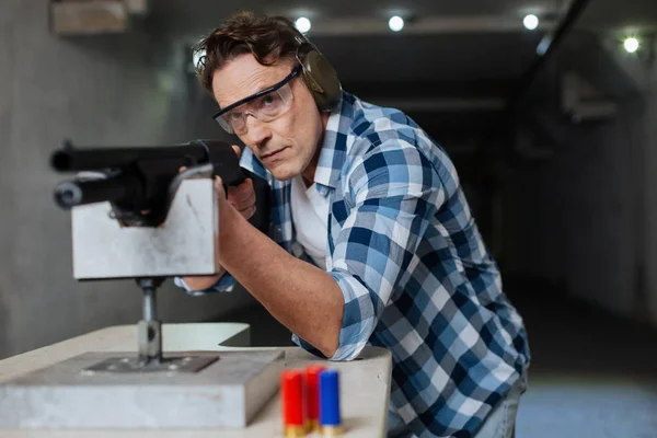 Confident brutal man wearing safety glasses — Stock Photo, Image