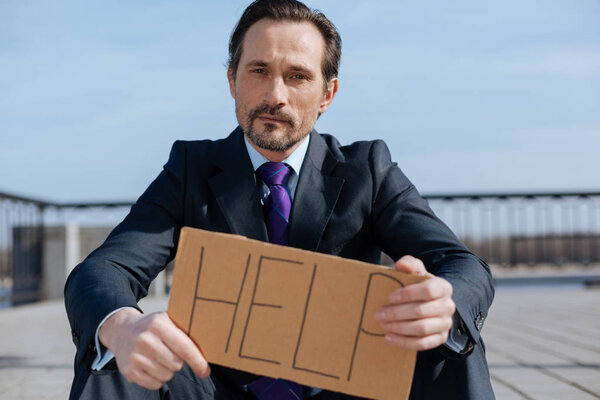 Portrait of sad man looking straight on camera