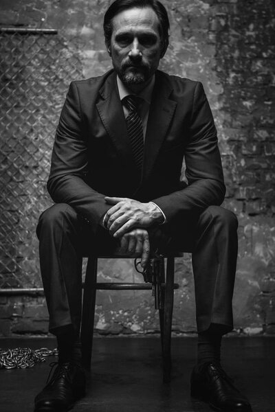 Dangerous criminal leader posing with his favorite weapon