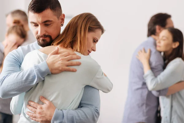 Brave male person embracing his coworker — Stock Photo, Image