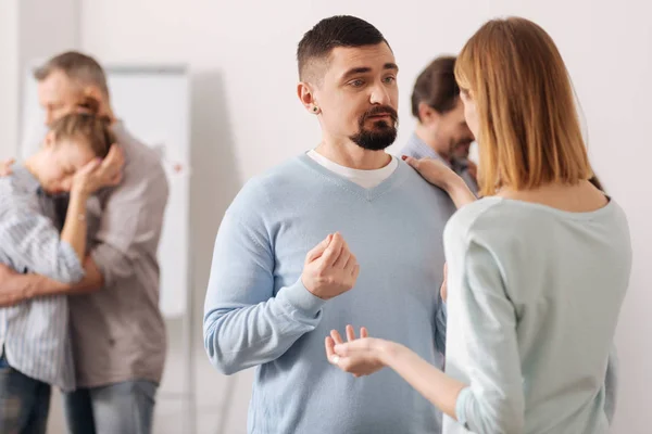 Worried young man standing in the foreground — Stock Photo, Image