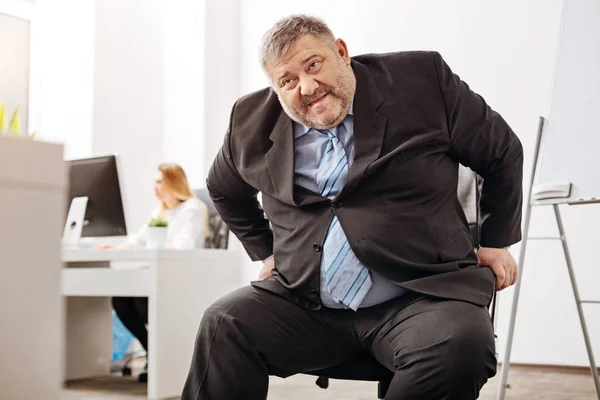 Unhealthy obese worker having trouble with a chair — Stock Photo, Image