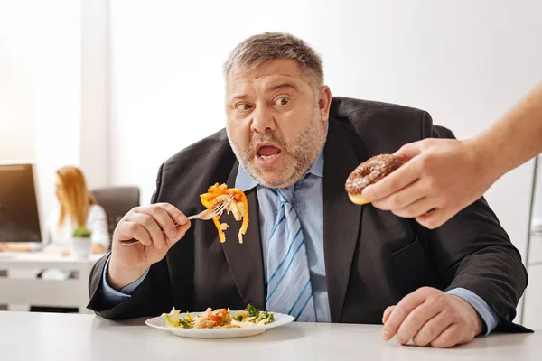 Comical puffy guy being seduced by junk food — Stock Photo, Image