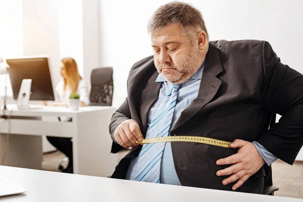Hardworking employee suffering from excess weight — Stock Photo, Image