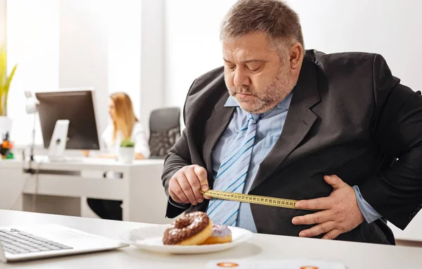 Hilarious white collar worker using a measuring tape — Stock Photo, Image