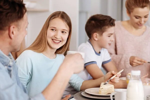 Chica alegre disfrutando de la cena con su familia —  Fotos de Stock