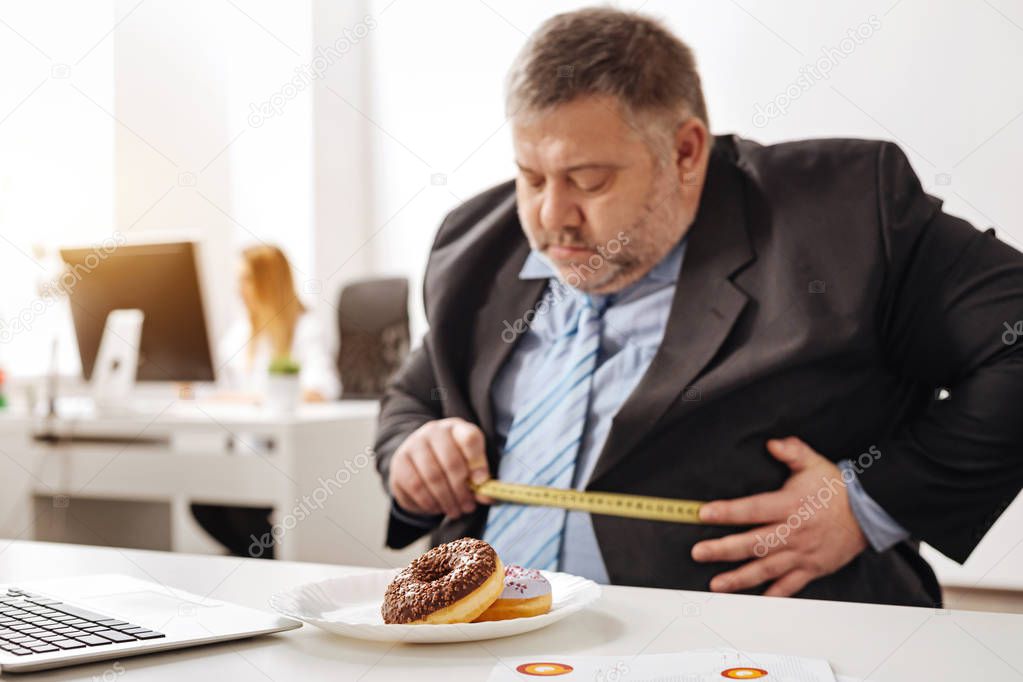 Unhealthy obese employee looking concerned