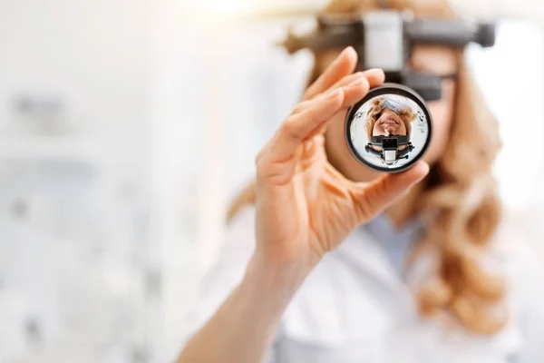 Professional female doctor using indirect ophthalmoscope — Stock Photo, Image