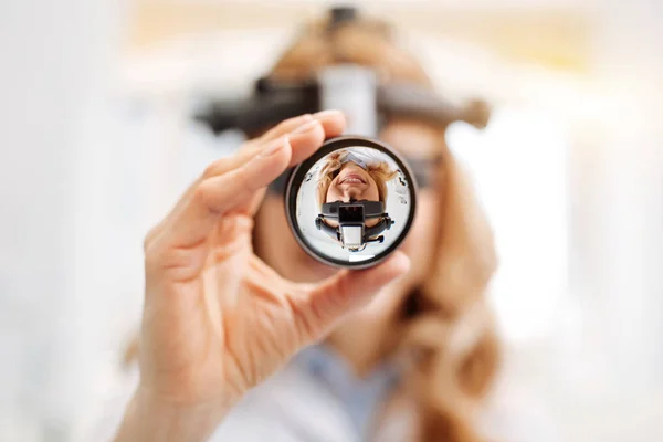 Professional female doctor using indirect ophthalmoscope — Stock Photo, Image