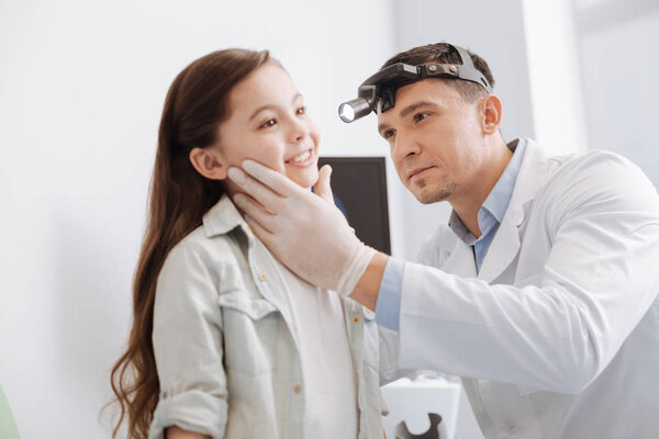 otolaryngologist going to examine his patient