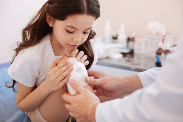 young girl sitting in front of doctor