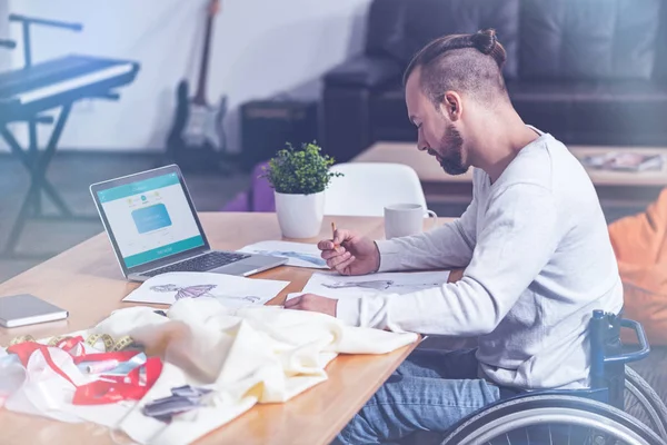 Young handicap designing clothes in studio — Stock Photo, Image