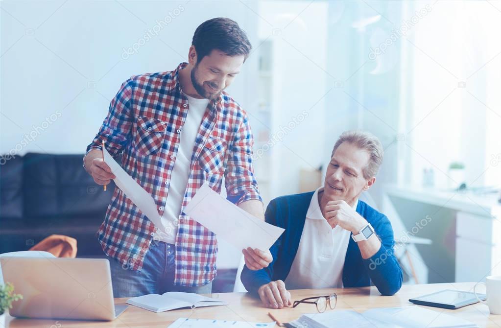Smiling male colleagues working together in the office
