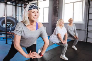 Cheerful nice women visiting aerobic classes clipart