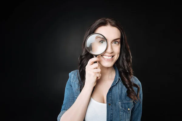 Funny female playing with magnifier — Stock Photo, Image