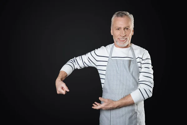 Handsome elderly male person holding fictitious pan — Stock Photo, Image