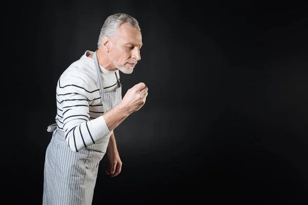 Serious man keeping his right hand bent in elbow — Stock Photo, Image