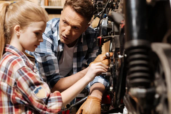 Fine local tinker teaching his daughter doing a checkup — Stock Photo, Image