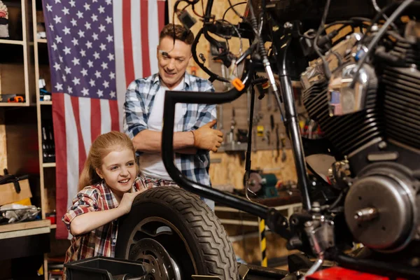 Adorable little mechanic checking the tire — Stock Photo, Image