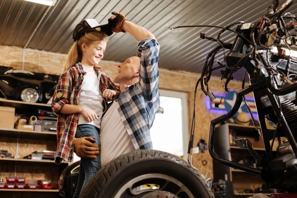 Charming adorable girl trying on dads cap — Stock Photo, Image