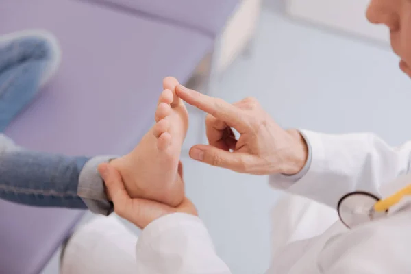 Gentle competent rheumatologist running diagnostic procedure — Stock Photo, Image