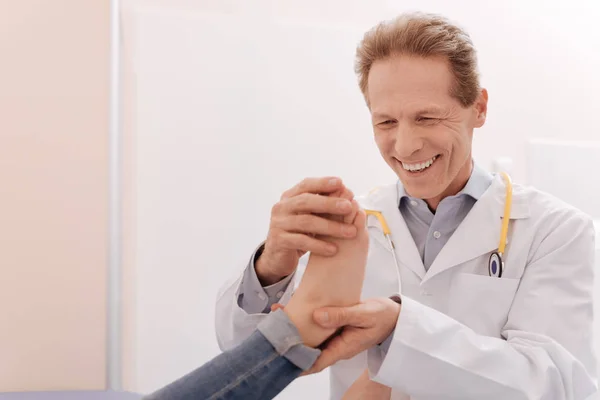 Enthusiastic excellent rheumatologist happy seeing his patient healthy — Stock Photo, Image