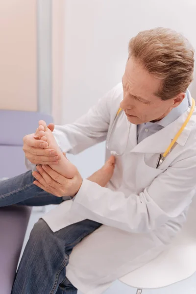 Focused qualified rheumatologist looking concerned — Stock Photo, Image